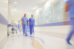 Blurred image of medical professionals walking through the hospital corridors